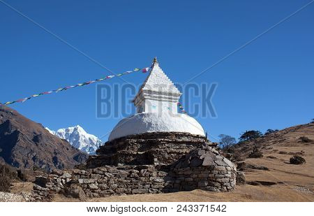 Buddhist White Stupa With Prayer Flags Near Namche Bazaar On The Way To Everest Base Camp, Khumbu, S