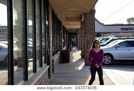Joliet, Illinois / United States - August 7, 2017: A Girl Walks Past The Front Entrance Of The Abri 