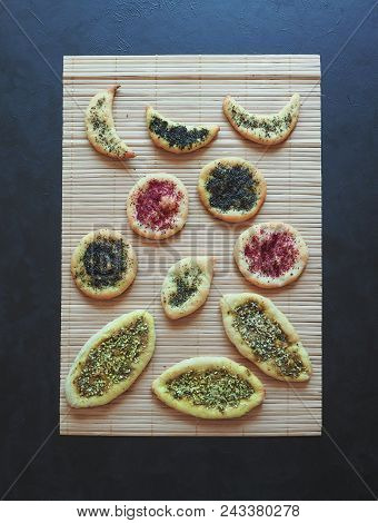 Herb Scones With Spices On A Bamboo Napkin On A Black Table.