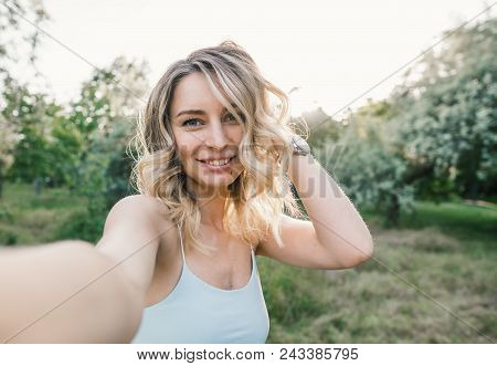Stylish Modern Girl Taking A Selfie Out In The Park.