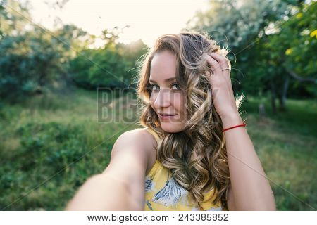 Stylish Modern Girl Taking A Selfie Out In The Park.