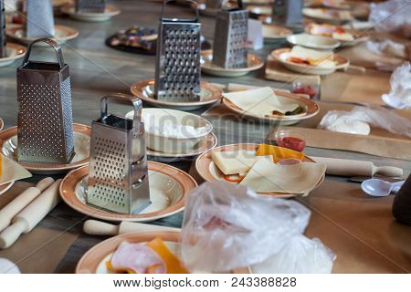 Set Of Kitchen Stainless Tools And Ingridients For Cook For Many People On Wooden Background. Concep