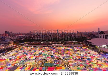 Dramatic Sunset Sky Over Night Flea Market Aerial View