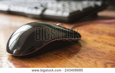 Black Computer Laser Mouse On Table With Keyboard