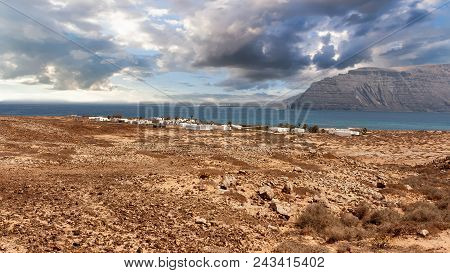 Scenic View Of Pedro Barba Village Under A Sky With Clouds. Ocean On The Background. La Graciosa, La