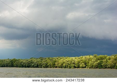 Dark Storm Clouds With Background. Dark Clouds Before A Thunder-storm At Riverside Of Danube