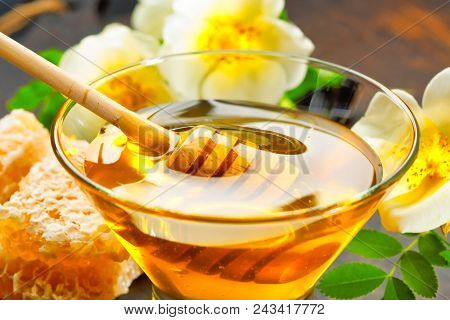 Honey Background. Honey With Wooden Honey Dipper On Wooden Table