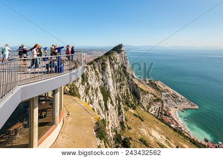 Gibraltar, Uk - May 18, 2017: Tourists And Barbary Apes On The Viewing Platform With The Rock And Th