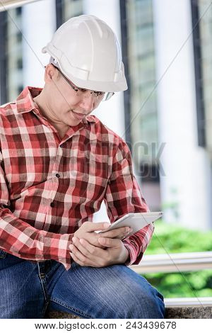 Asian Business And Engineer Man With Red Scott Shirt Has Planning And Working For Design Buiding And