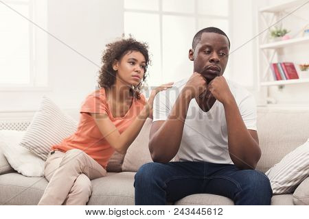 Young African-american Couple Making Peace After Quarreling At Home, Man Still Feeling Offended. Fam