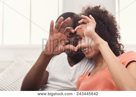 Couple Selfie. Happy African-american Couple Smiling At Camera Through Heart Made Of Their Hands, Co