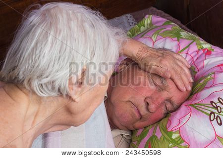 Elderly 80 Plus Year Old Man In A Home Bed And His Wife. Illness, Aging, Unhealthy Concepts
