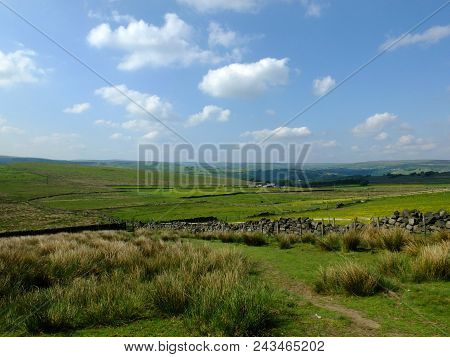 Scenic View Of A Path On The Edge Of Moorland In Calderdale West Yorkshire With Rough Tussock Grass 