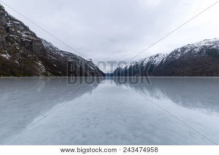Hardanger Fjord Frozen Smooth In Winter With Sheds Norway