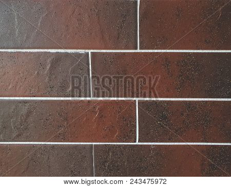 Close Up View Of Tile Brick Ceramic Granite Panels Made In The Color Of Brown. Fragment Of The Surfa