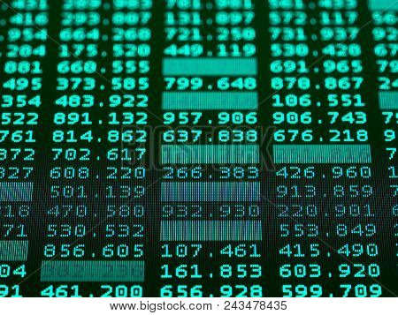 Concept Of Financial Data On A Monitor. Display Of Stock Market Quotes On Dark Background. Photo Of 