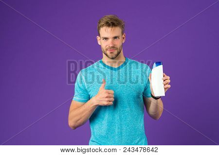 Man Show Thumbs Up With Shampoo Bottle On Violet Background. Bearded Man Like Gel Tube On Purple Bac
