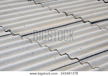 A Fragment Of A Gray Slate Roof Of An Old Sample Made Of Asbestos Material