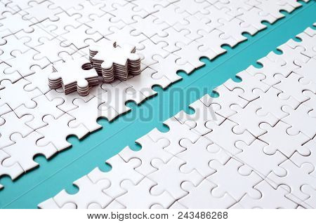The Blue Path Is Laid On The Platform Of A White Folded Jigsaw Puzzle. The Missing Elements Of The P