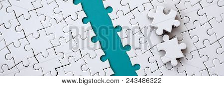 The Blue Path Is Laid On The Platform Of A White Folded Jigsaw Puzzle. The Missing Elements Of The P