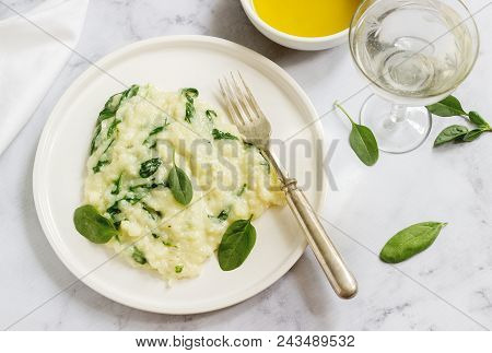 Gentle Cream Risotto With Spinach, Served With Wine. Light Background, Selective Focus.