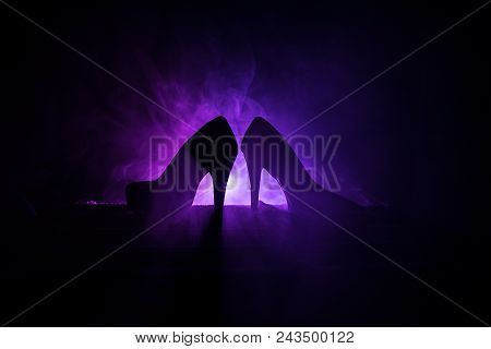 Black Suede High Heel Women Shoes On Dark Toned Foggy Background. Close Up. Women Power Or Women Dom