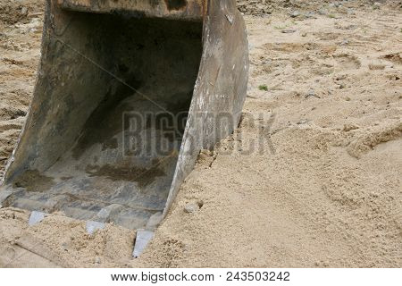 An Old Vintage Beatup Construction Loader Sitting On Beach Sand Taking A Rest From Work.