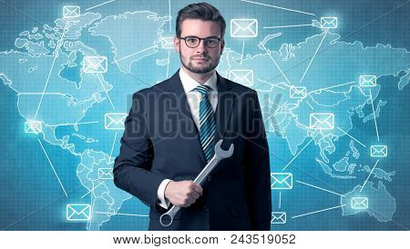 Businessman holding tool with global map graphic on the background