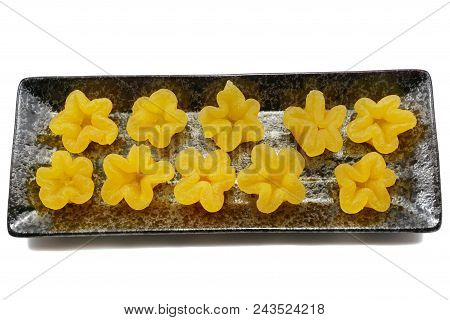 Thai Dessert Style, Top View Of Thong Yip On A Black Plate Isolated On White Background,  (trouxas D