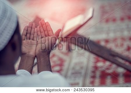 Top Viewv Of African Muslim Man Making Traditional Prayer To God While Wearing A Traditional Cap Dis