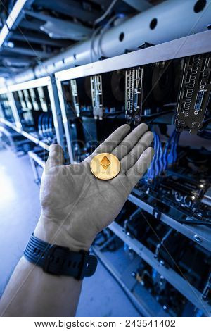 Hand Holding Golden Etherium Coin, Cryptocurrency Mining Unit