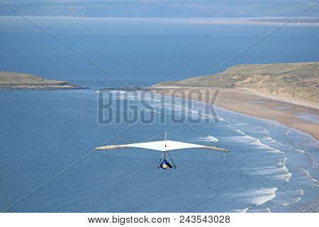 Hang Glider Above The Coast At Rhossili Beach