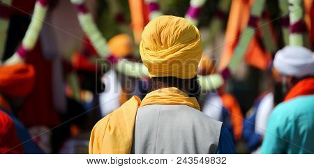 Sikh Man With Yellow Turban During The Religious Rite In The City