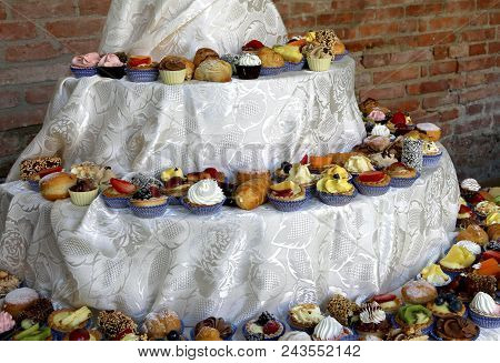 Table Full Of Sweets And Pastries With Custard During Refreshments