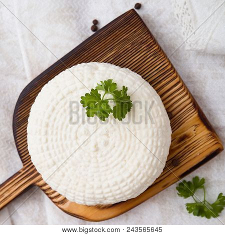 Top View On Big Head Of Homemade Organic White Cheese On Wooden Board.