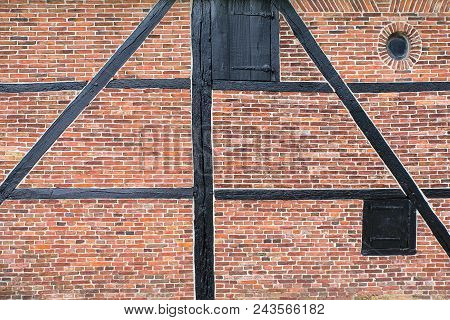 Brick Wall Of Half-timbered House Or Water Mill With Wooden Beams