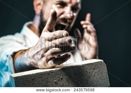 Karate Fighter Showing Kick By Hand. Karate Man Is Preparing For Competition. Screaming Karate Maste