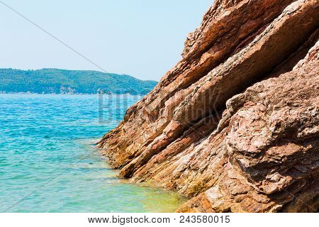 Scenic Layered Rocks In The Sea. Rafailovici. Montenegro. Beautiful Nature Horizontal Wallpaper