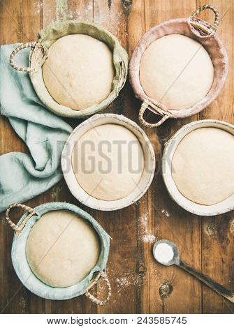 Sourdough For Baking Homemade Wheat Flour Bread In Baskets, Over Rustic Wooden Kitchen Table Backgro