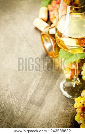 Glass Of White Wine On Vintage Wooden Table
