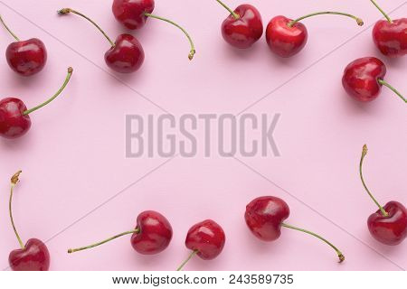 Spring Or Summer Mood Concept. Flatlay Of Cerry Over Pastel Pink Background. Top View With Space For