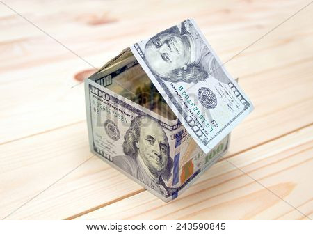 Dollars money in the shape of a house. Mortgage concept means hypothecation or instalments. House made of money
