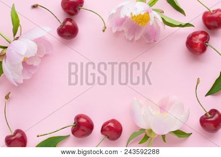 Spring Or Summer Mood Concept. Flatlay Of Cerry, Sweet Cones And Peonies Over Pastel Pink Background
