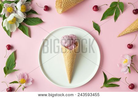 Flatlay Of Pink Ice Cream Scoops, Cerry, Sweet Cones And Peonies Over Pastel Pink Background. Top Vi