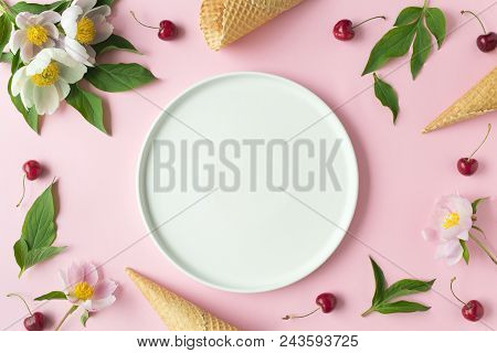 Flatlay Of Cerry, Sweet Cones And Peonies Over Pastel Pink Background. Top View With Space For Your 