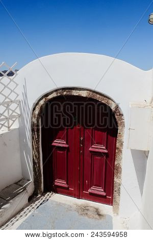Main Door Entrance Against A Blue Summer Sky. Santorini Greece
