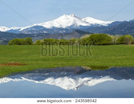 Longs Peak Reflects In The Waters Along A Country Road In Longmont Colorado