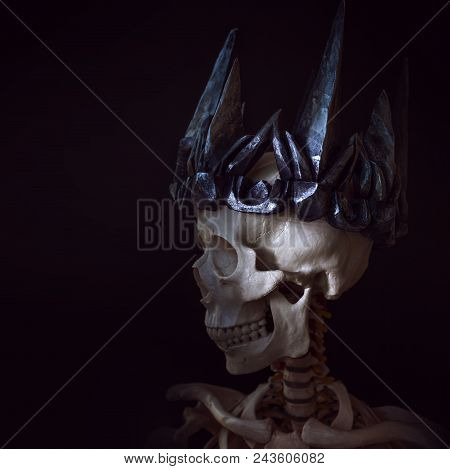 The Skull In The Crown. Grim Necromancer In Gothic Crown. Black Background, Halloween Concept