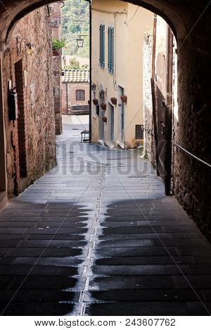 medieval narrow sreet in asciano, Italy