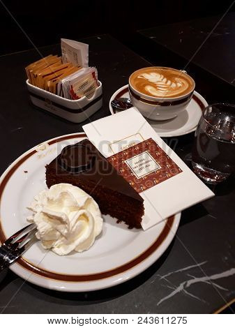 Vienna, Austria - December 16, 2017: Original Sacher Torte With Cream And Fork At Sacher Cafe